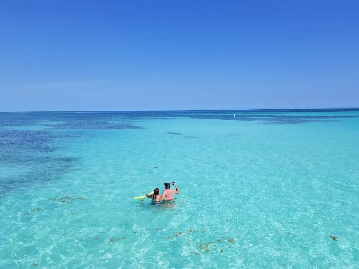 Couple enjoying their time in crystal clear waters of Florida Keys