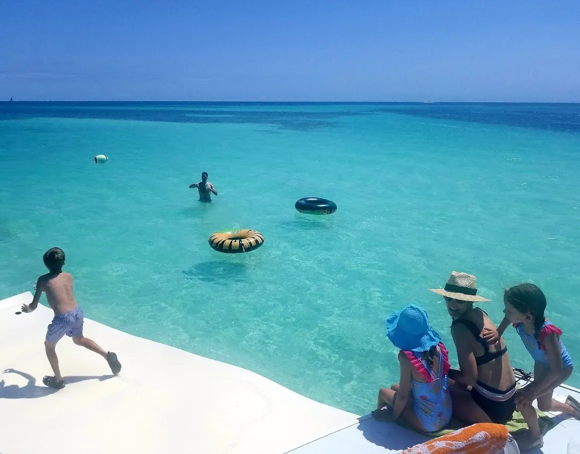 Family enjoying their fun in the sun on a water mat during the sandbar combo trip