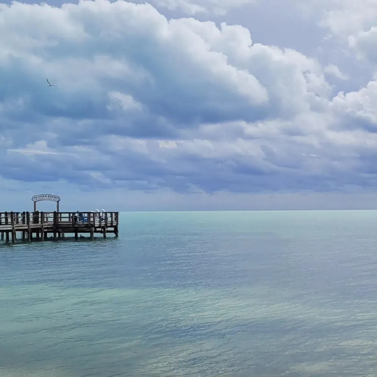 Calm ocean view with pier and cloudy sky in Islamorada