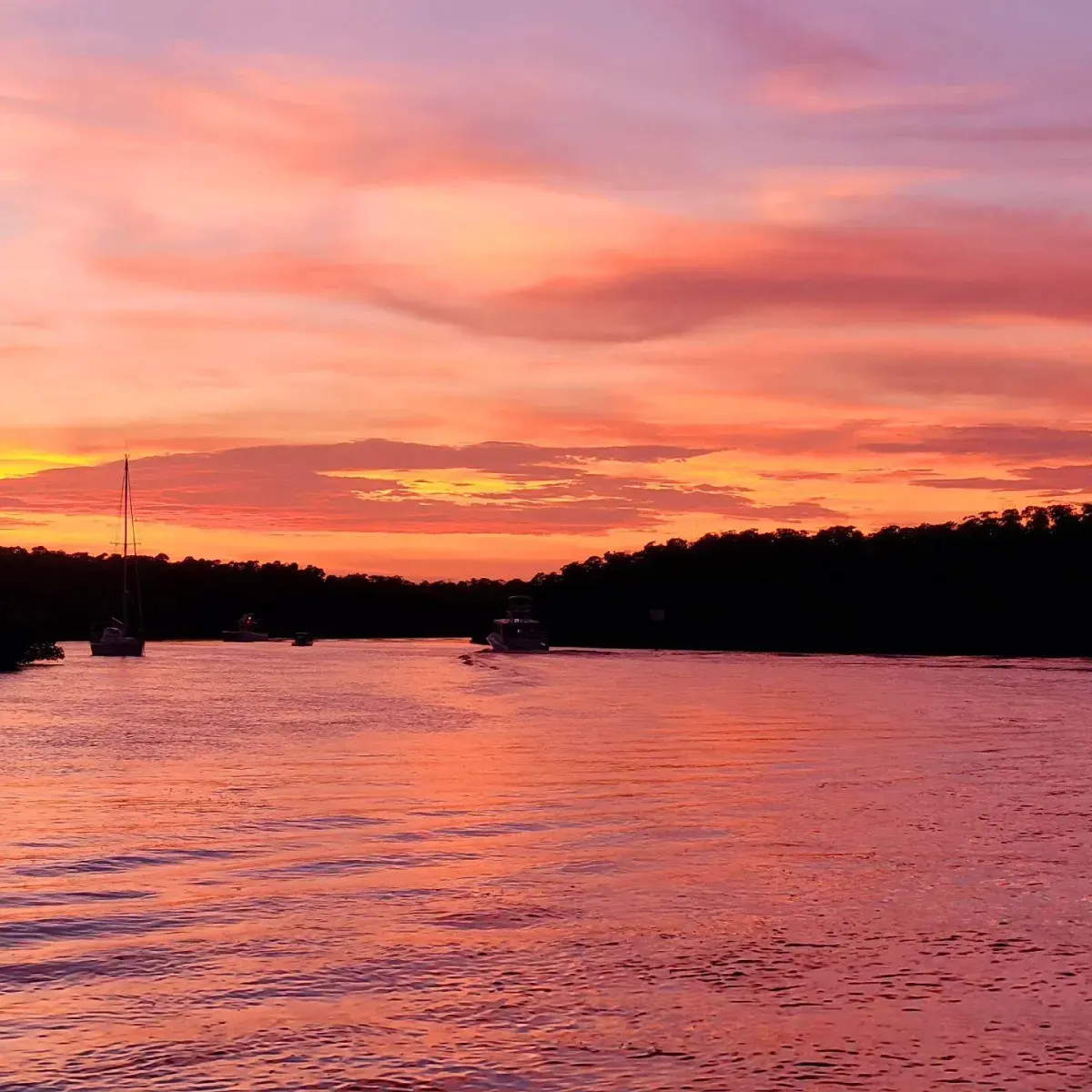 Sunset over calm waters with boats during a charter in Islamorada