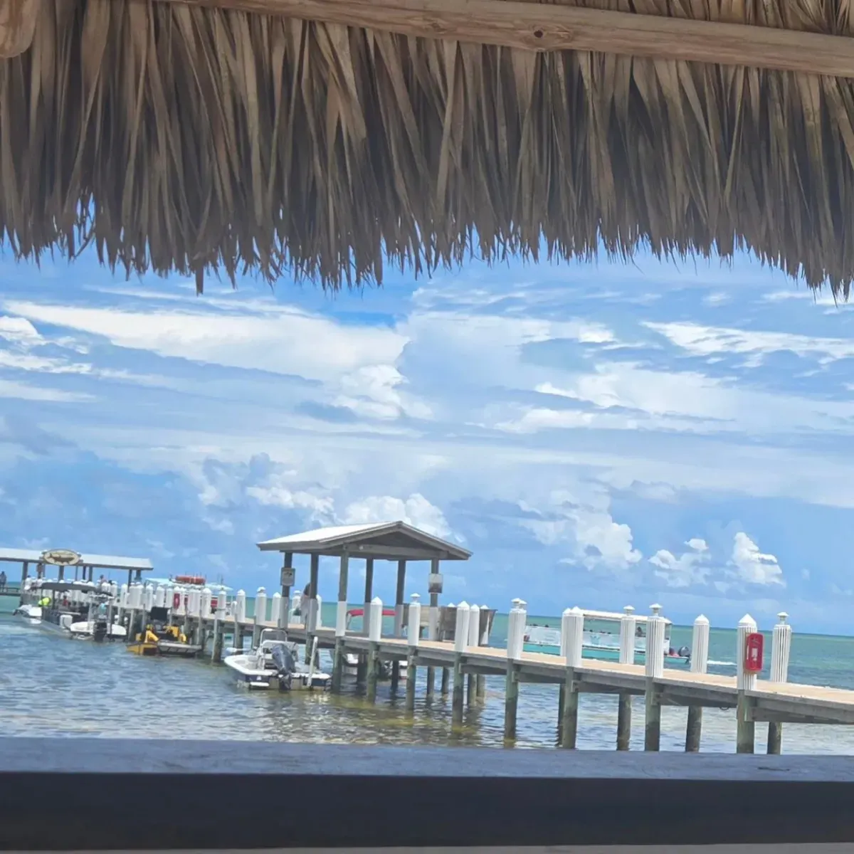 Dock and boats on clear blue water in Islamorada with Clearly Unique Charters