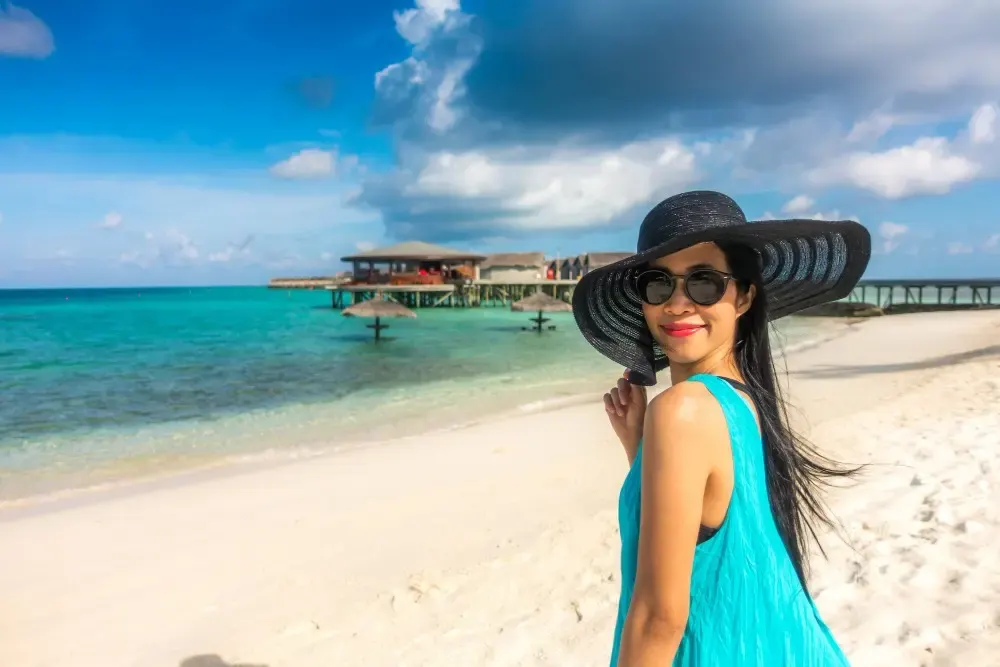 Happy young woman at a water villa