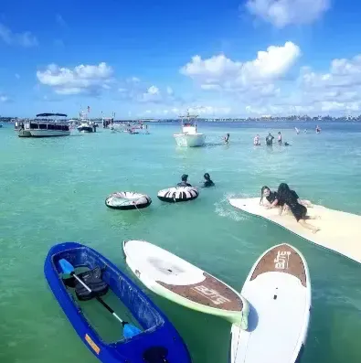 Paddleboards, kayak and floats on the clear water at an Islamorada sandbar